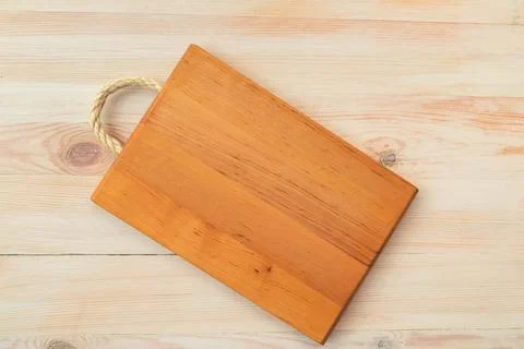 Food background. Top view of empty wooden cutting board on wooden planks vint Stock Photos