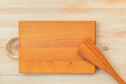 Food background. Top view of empty wooden cutting board and spatula on planks Stock Photos