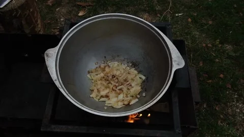Food in a cauldron on the grill. Stock Footage 173504672