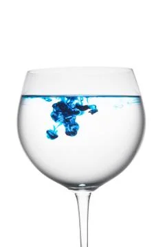 Food coloring diffuse in water inside wine glass area for slogan or advertisi Stock Photos