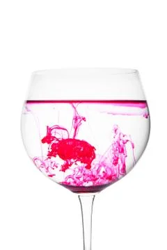 Food coloring diffuse in water inside wine glass area for slogan or advertisi Stock Photos