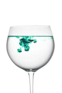 Food coloring diffuse in water inside wine glass area for slogan or advertisi Stock Photos