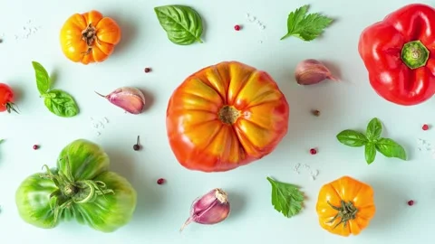 Food composition. Tomatoes, basil, garlic and pepper on pastel blue background Video stock 282315949