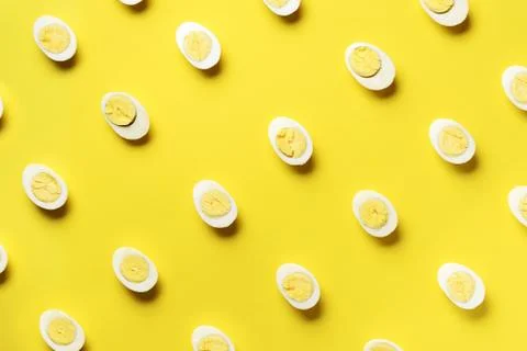 Food concept with boiled eggs pattern on yellow background. Top view. Creative Stock Photos