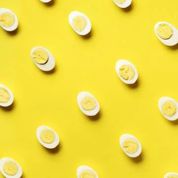 Food concept with boiled eggs pattern on yellow background. Top view. Creative Stock Photos