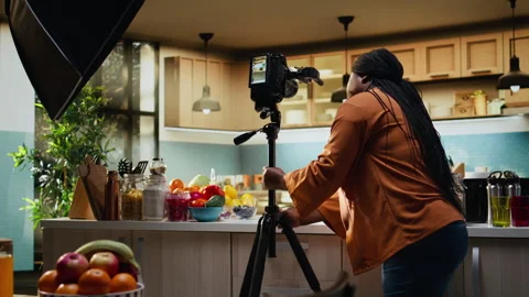 Food content creator fine tuning camera settings before filming recipe video Stock Footage 333608971