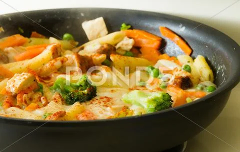 Food cooking in a pan Stock Photos