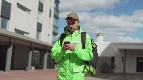 Food courier with backpack using navigation app Stock Footage 113992458