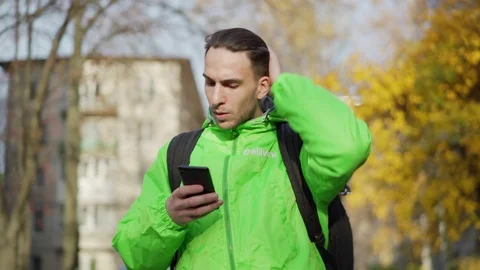 Food courier using mobile navigation app Stock Footage 124827484
