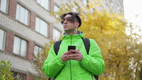 Food courier using mobile navigation app being lost Stock Footage 124827493