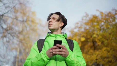 Food courier using mobile navigation app to find direction Stock Footage 124827658
