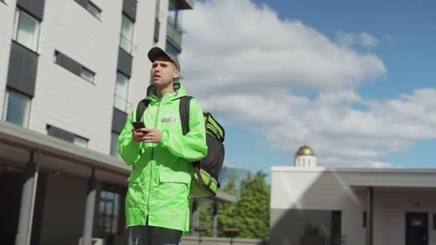 Food courier using smartphone navigation app Stock Footage 113992452