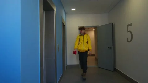 Food delivery man next to the elevator Stock Footage 236897943