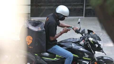 Food delivery worker browsing phone Stock Footage 147524831