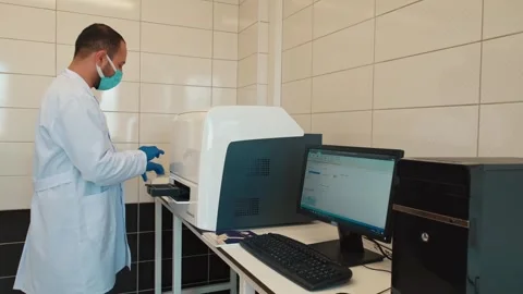 Food Engineer Operating Microplate Reader and Analyzing Data on Computer Video stock 308043859