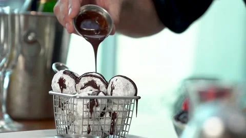 Food hand serving doughnuts donuts waiter chef chocolate sugar slomo closeup Video stock 221270646