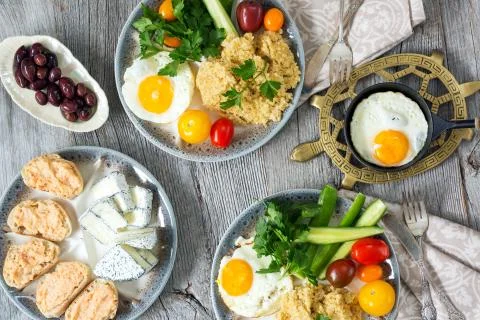 Food, healthy Breakfast, porridge, eggs, vegetables and sandwiches with caviar Stock Photos