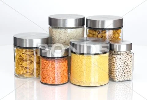 Food ingredients in glass jars, on white background Stock Photos