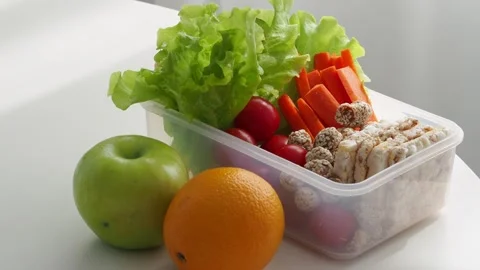 Food in a lunch box on the table. A balanced healthy snack for a lunch break at  Stock Footage 240317339