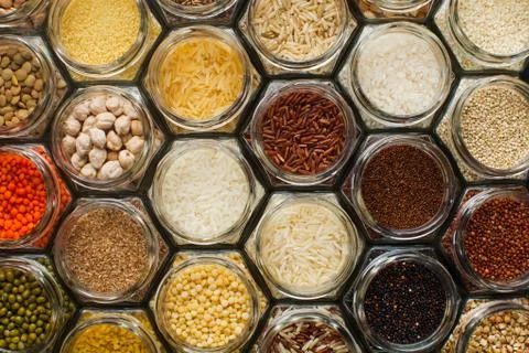 Food pattern background - beans and cereals in jars Stock Photos