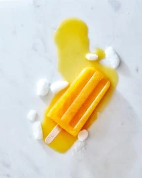 Food pattern from splashes of melting fruit ice cream lolly of ice slices on a Stock Photos