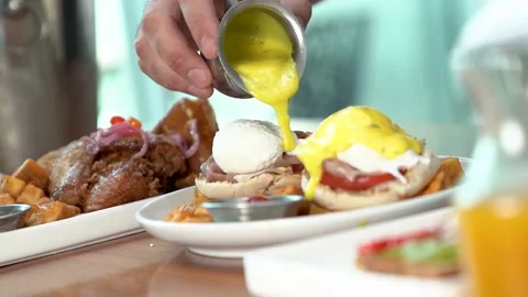 Food plate hand serving Egg Benedit on table chef waiter breakfast meal Video stock 221270832