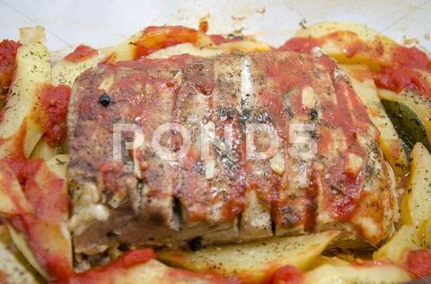 Food - Pork steak with baked potatoes and spices Stock Photos