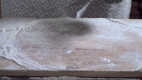 Food preparation. Flat dough dropping into the Flour on the wooden kitchen board Stock Footage 299632660