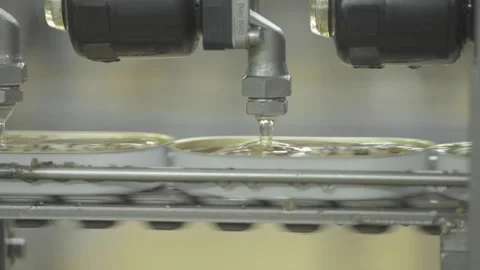 Food Processing Factory Applying Oil to Canned Seafood Stock-Footage 232962965