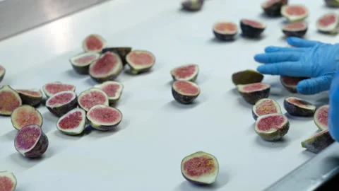Food processing, sliced fresh figs on table Stock Footage 247980335