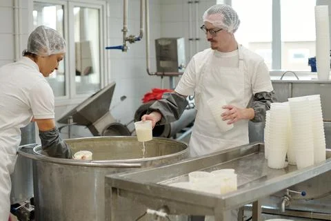 Food Processing Workers Preparing Dairy Products Stock Photos