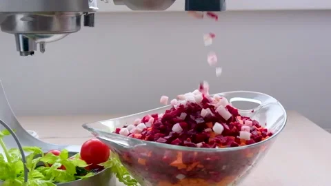 Food processor dicing beets and onions falling slow motion cubes in a glass Stock Footage 233561695