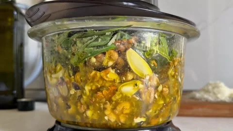 Food Processor Pulsing Fresh Ingredients for Homemade Green Pesto Stock Footage 344577503
