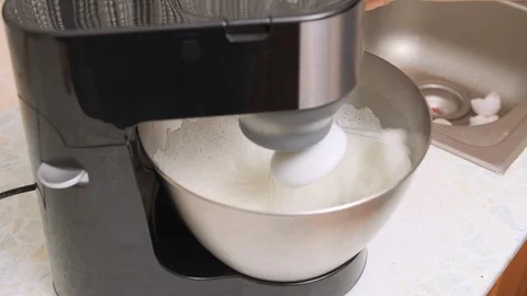 Food processor whips egg protein in a metal bowl. mixer beat the egg whites into Stock Footage 122992531