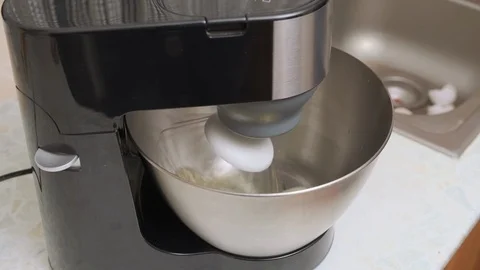 Food processor whips egg protein in a metal bowl. mixer beat the egg whites into Stock Footage 123052830
