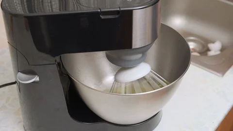 Food processor whips egg protein in a metal bowl. mixer beat the egg whites into Stock Footage 123175982