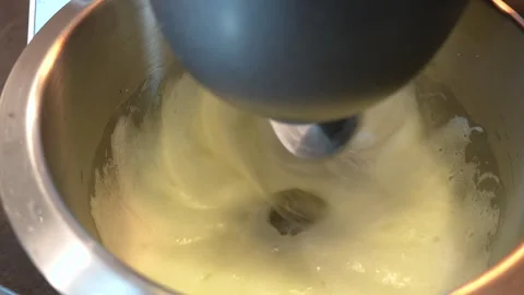 Food processor whips egg protein in a metal bowl. Stock Footage 287815457