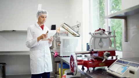 Food production technician checking notes at dairy products factory Stock Footage 161194740