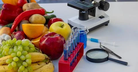 Food Quality Testing: Microscope and Fresh Fruits and Vegetables Stock Photos