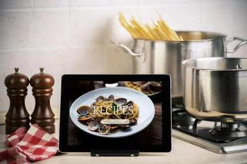 Food recipes tablet computer on rustic wooden table Stock Photos