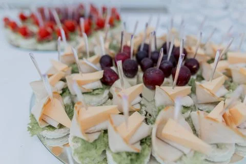 A food an snacks on the buffet table at the celebration of wedding birthday Stock Photos
