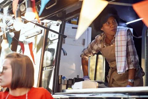Food truck employee taking orders from customers Stock Photos