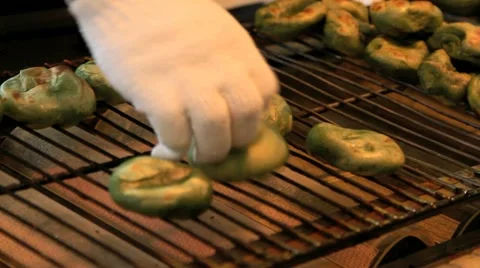 Food vendor cooking japanese sweets at a festival. Stock Footage