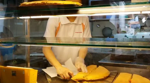 Food vendor preparing and packing Chinese pancakes SINGAPORE CHINESE PANCAKE--1 Stock Footage 33654055