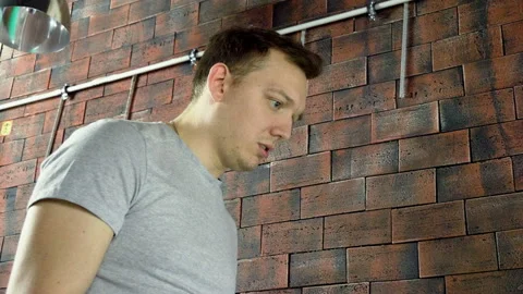 Foosball. One man playing a table football or kicker with miniature players. 4K Stock-Footage 110793645