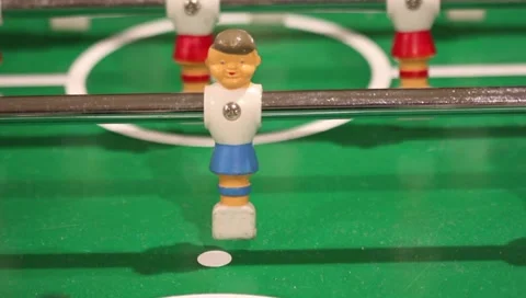 Foosball player kicking ball Stock Footage 225379185