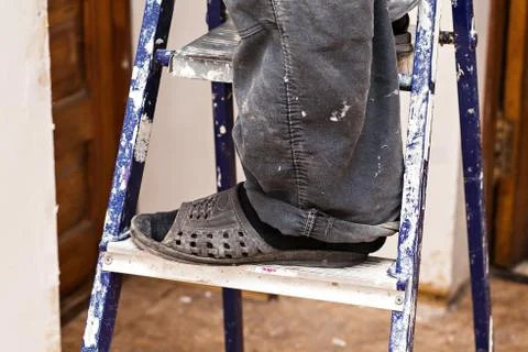 Foot of a builder on a ladder Stock-Fotos