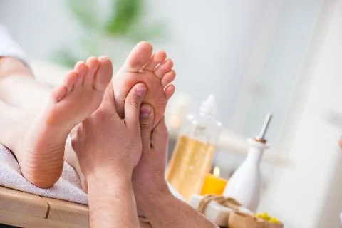 Foot massage in medical spa Stock Photos