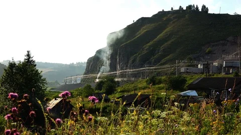 At the foot of the mountain there is a freight train Stock Footage 84630253