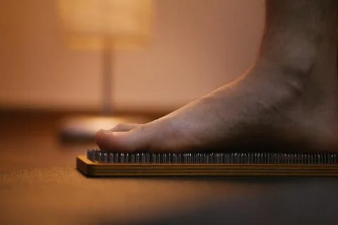 Foot on nails, nail on sharp, no pain, yoga Stock Photos